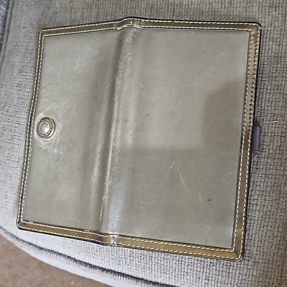 Coach checkbook silver or gray.